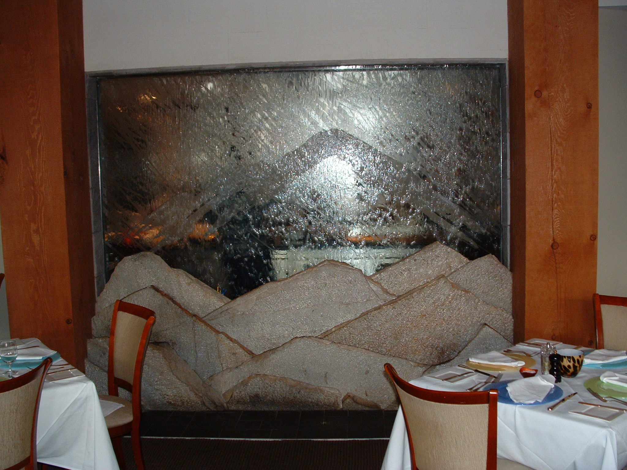 Seattle, WA. Cascadian restaurant - 4 star. 10 ft x 8ft tall-  in thick glass backdrop with mountain scene sandblasted into it, 2  in. thick pieces make up a foreground Mountain range, fiber optic glass lighting this pc look into the chefs kitchen new construction.