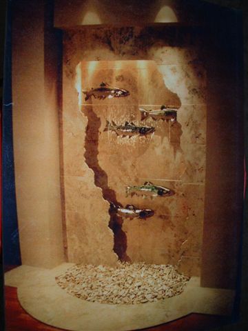 This piece is in a residential entry way located near lake Sammamish WA. It is 8'-6" by 12' tall and has five 25" racue glazed salmon mounted out in front of the water. There is lighting within the valance and a remote basin located 50' away.