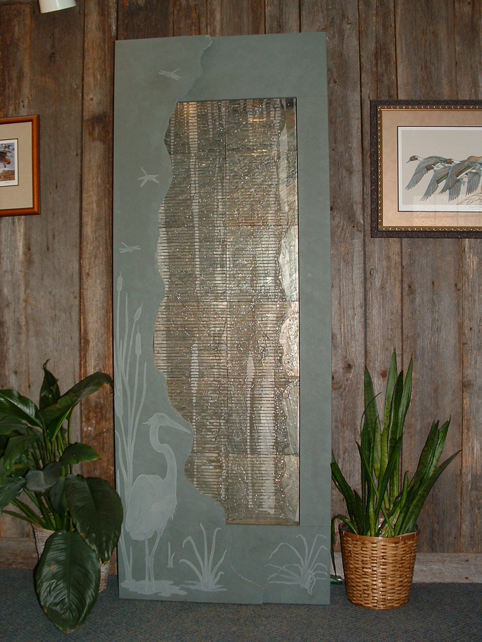Olympia, WA. Hortin dental. 40 in x 7 ft tall. A rustic slate tile wave wall backdrop, slate slab foreground with sandblasted images, lighting within the valance. Existing building.