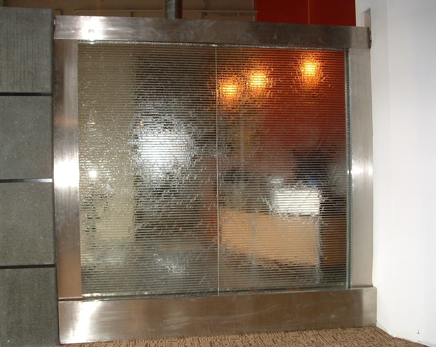 Impex development conference room privacy divider 8 ft x 8 ft tall horizontal grooves in glass stainless steel structure, lighting within valance, new construction remote pump location